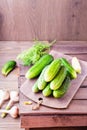 A bunch of fresh cucumbers, dill and garlic on a wooden table Royalty Free Stock Photo