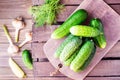 A bunch of fresh cucumbers, dill and garlic on a wooden table Royalty Free Stock Photo