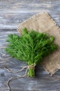 Bunch of fresh dill on a wooden surface