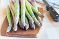 Bunch of fresh green asparagus on wooden board, horizontal
