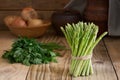 Bunch of fresh green asparagus on a wooden table. Fresh vegetables in a rustic interior. Royalty Free Stock Photo