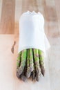 Bunch of fresh green asparagus on a wooden table, vertical Royalty Free Stock Photo