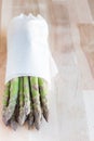 Bunch of fresh green asparagus on wooden table, vertical, copy s Royalty Free Stock Photo