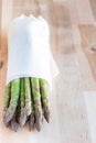 Bunch of fresh green asparagus on wooden table, vertical, copy space Royalty Free Stock Photo