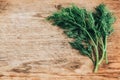 Bunch of fresh green dill on wooden rustic background. Top view. Copy, empty space for text Royalty Free Stock Photo