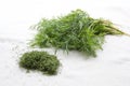 A bunch of fresh and a hill of dried dill