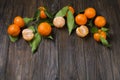 Fresh tangerine oranges on a wooden table. Peeled mandarin. Halves, slices and whole clementines closeup. Royalty Free Stock Photo