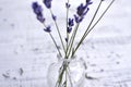 Bunch of fresh natural lavender flowers in glass bottle over wooden background Royalty Free Stock Photo