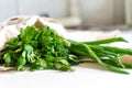 Bunch of fresh parsley, dill and spring onion in canvas reusable shopping tote bag on kitchen table