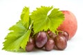 Bunch of pink grapes with leaves and ripe peach isolated on a white background Royalty Free Stock Photo