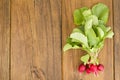 Bunch of fresh radish on brown wooden table. Royalty Free Stock Photo