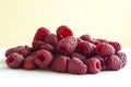 A bunch of fresh raspberries on a white background. Close-up, red berry.