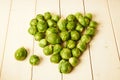 Bunch of fresh raw Brussel sprouts on a white wood table Royalty Free Stock Photo