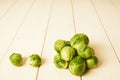 Bunch of fresh raw Brussel sprouts on a white wood table Royalty Free Stock Photo