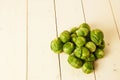 Bunch of fresh raw Brussel sprouts on a white wood table Royalty Free Stock Photo