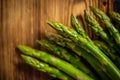 Bunch of fresh raw garden asparagus on wooden table background.