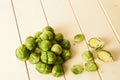 Bunch of fresh raw Brussel sprouts on a white wood table Royalty Free Stock Photo