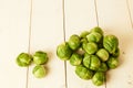 Bunch of fresh raw Brussel sprouts on a white wood table Royalty Free Stock Photo