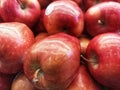 A bunch of fresh red apples on display in a fruit shop, close up