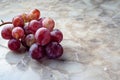 Bunch of fresh red grapes on marble background Royalty Free Stock Photo
