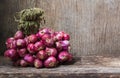 Bunch of fresh red onions on old wooden background Royalty Free Stock Photo