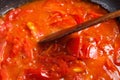 Bunch of fresh red tomatoes sliced stewed in a pan