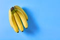 Bunch of fresh ripe bananas full of vitamins on purple background. Space for text