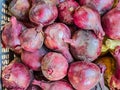 Bunch of fresh ripe onion heads lie on trading counter. Autumn agricultural fair. Texture surface background