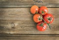 Bunch of fresh ripe red tomatoes over a rustic wood background Royalty Free Stock Photo