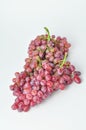 bunch of fresh seedless red grapes isolated on white background Royalty Free Stock Photo