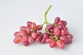 bunch of fresh seedless red grapes isolated on white background Royalty Free Stock Photo