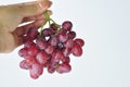 bunch of fresh seedless red grapes isolated on white background Royalty Free Stock Photo