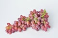 bunch of fresh seedless red grapes isolated on white background Royalty Free Stock Photo