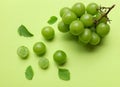 bunch of fresh sweet green shine muscat (vitis vinifera) grape and leaf isolate on green background Royalty Free Stock Photo