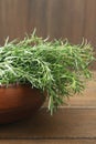 Bunch of fresh tarragon in bowl on wooden table Royalty Free Stock Photo