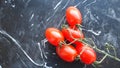 A bunch of fresh tomatoes on a stone cutting board Royalty Free Stock Photo