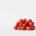 Bunch of fresh vegetables - red cherry tomatoes on a white background. Square. Copy space Royalty Free Stock Photo
