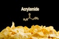 A bunch of fried chips on a black background. Acrylamide formula on a black background. Empty space for text