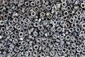 Bunch of galvanized hexagon nuts for bolts for fasten multiple parts together, hardware fasteners Royalty Free Stock Photo