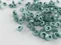 A bunch of galvanized nuts on a gray surface. Royalty Free Stock Photo