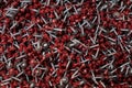 Bunch of galvanized self-drilling screws with washer and red hexagonal head, hardware background