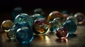 a bunch of glass marbles sitting on a wooden table top with a black background and a reflection of the glass marbles on the table Royalty Free Stock Photo