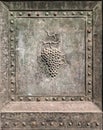 Bunch of grapes embossed in an old bronze door.