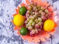 Bunch of grapes,lemon,orange,lime in a vase on a black and white background, close-up,with space for text,background, Royalty Free Stock Photo