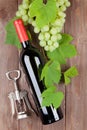 Bunch of grapes, red wine bottle and corkscrew Royalty Free Stock Photo