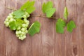 Bunch of grapes and vine on wooden table Royalty Free Stock Photo