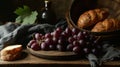 a bunch of grapes on a wooden plate next to a basket of bread