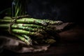 a bunch of green asparagus lies on a burlap on a wooden table.rustic style