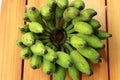 Bunch of green banana fruits on wooden background