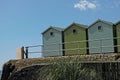 A bunch of green beach huts, blue sky, summer holidays Royalty Free Stock Photo